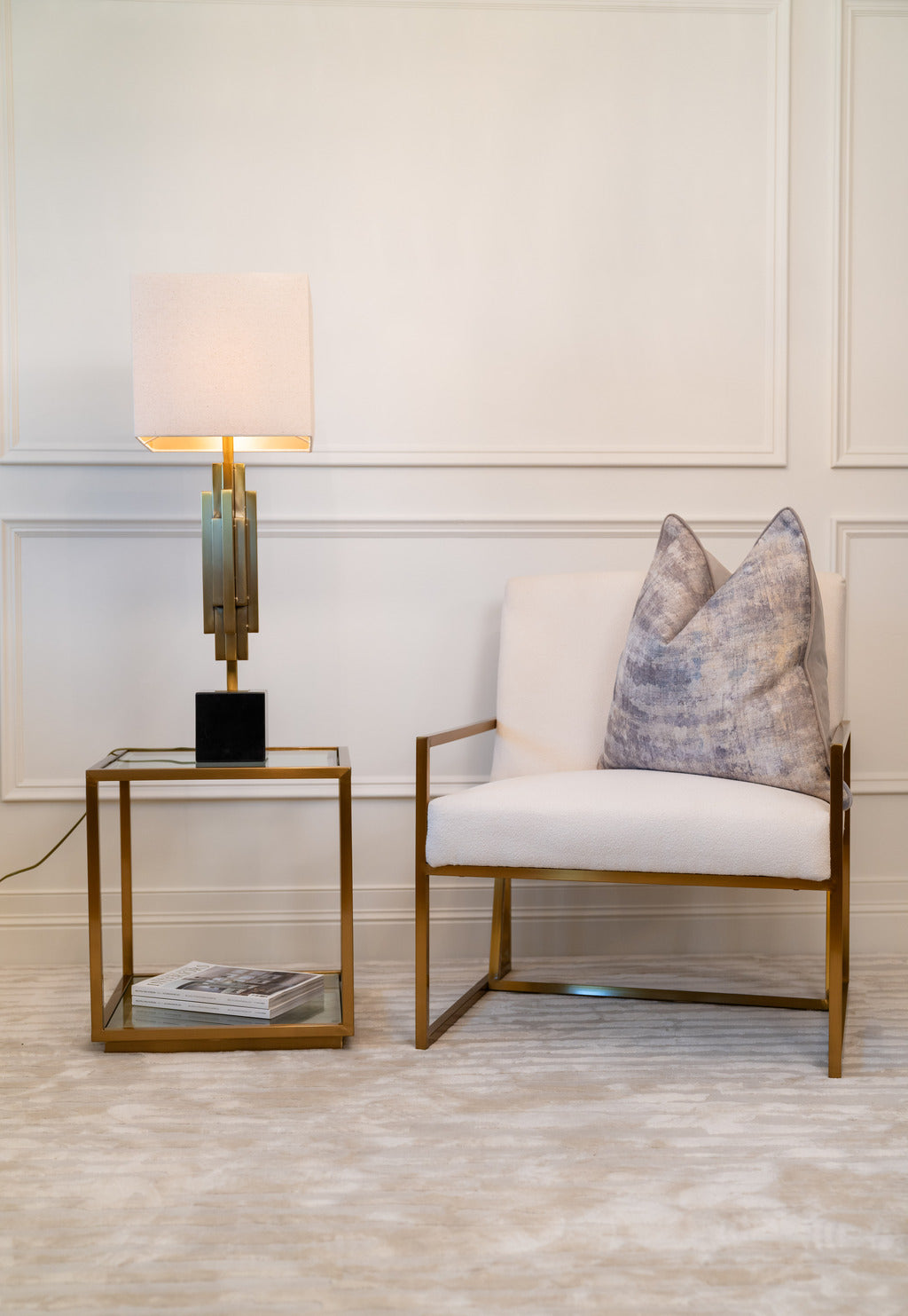 Gold lighting, gold furniture, gold tables, chair, pink lampshade, glass table